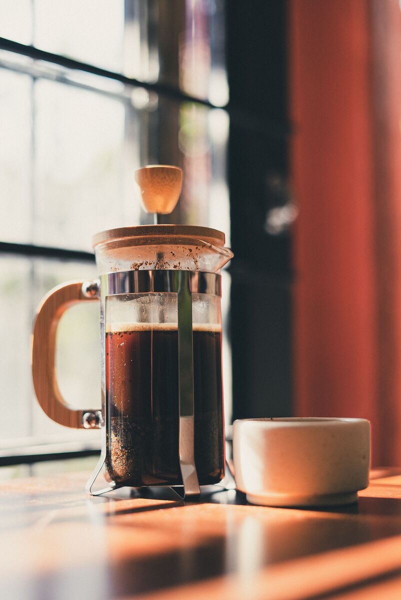 A French press full of brewed coffee